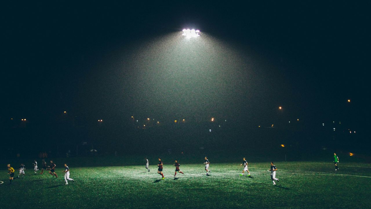 Players warm up on the pitch inside a football stadium during 2026 FIFA World Cup qualifying