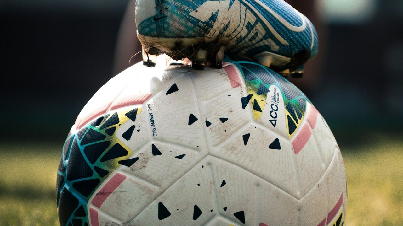 Players line up for a set piece inside a football stadium during OFC qualifying for the 2026 FIFA World Cup
